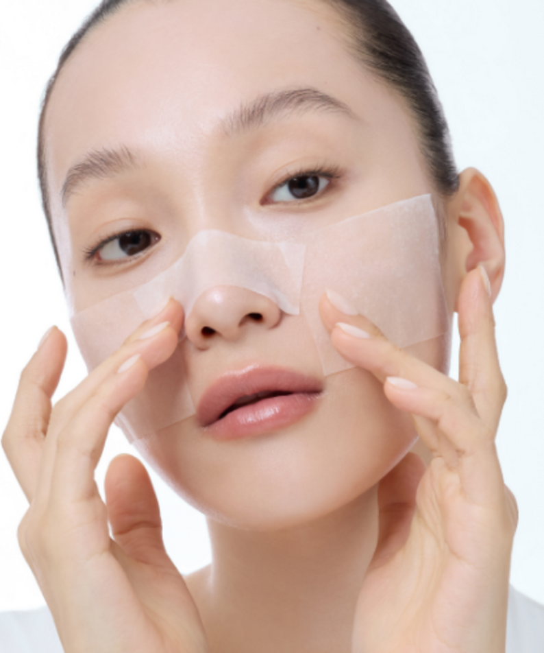 Woman applying KLAIRS Freshly Juiced Vitamin Hwajalmeok Pad 80 sheets to her face for skincare routine
