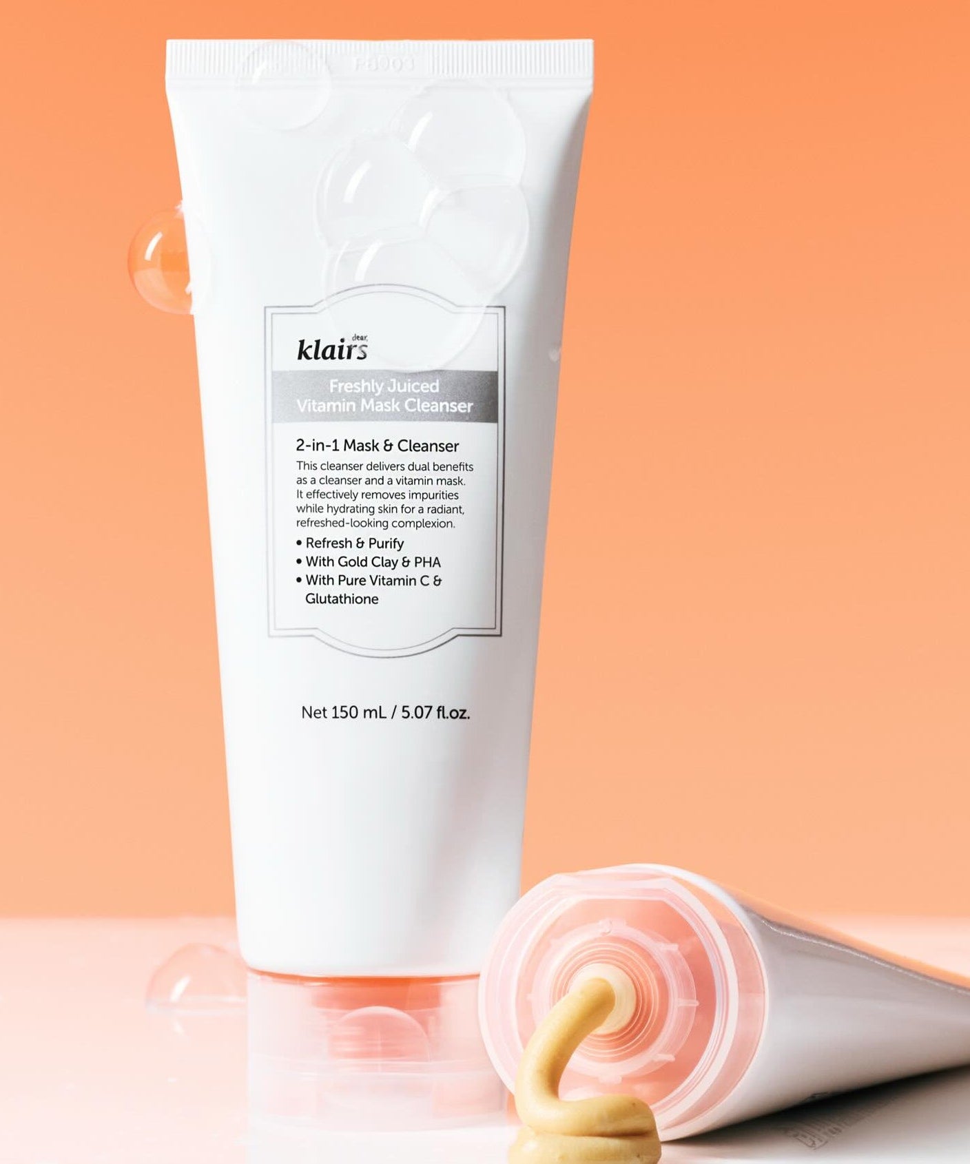 KLAIRS Freshly Juiced Vitamin Pack Cleanser 150ml with cleanser texture against orange background