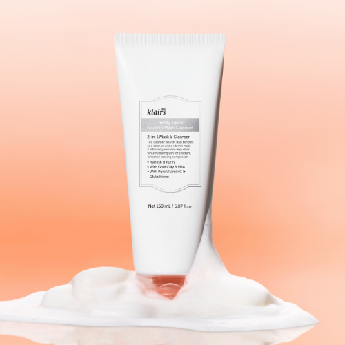 KLAIRS Freshly Juiced Vitamin Pack Cleanser 150ml tube on foamy surface with orange background
