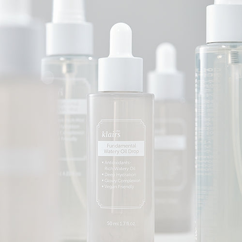 KLAIRS Fundamental Watery Oil Drop 50ml with rich hydration formula displayed among other skincare products.
