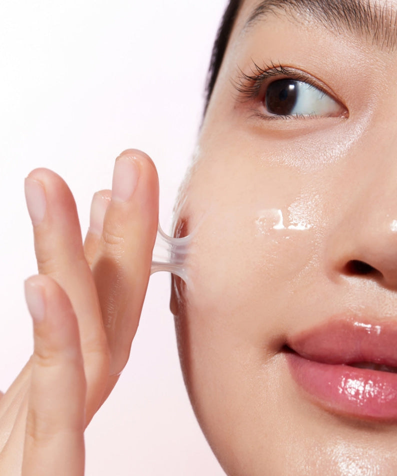 Woman applying KLAIRS Maple Energy Infusing Serum 30ml to face for glowing skin.