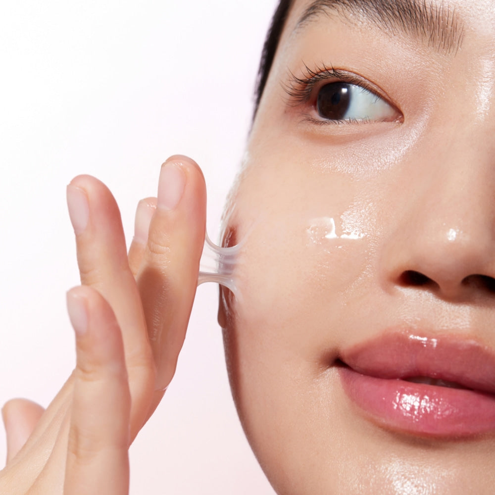 Woman applying KLAIRS Maple Energy Infusing Serum 30ml to face for glowing skin.