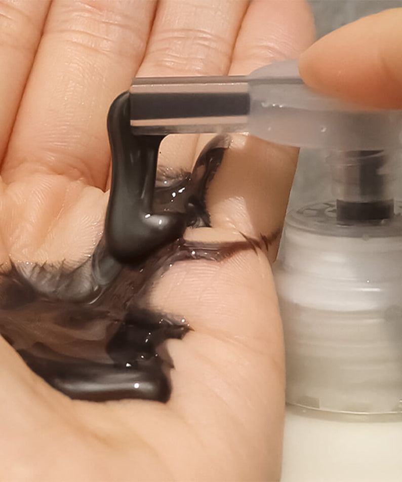 Applying LADOR ASH Silver Shampoo 300ml in hand, showcasing texture and color of the product