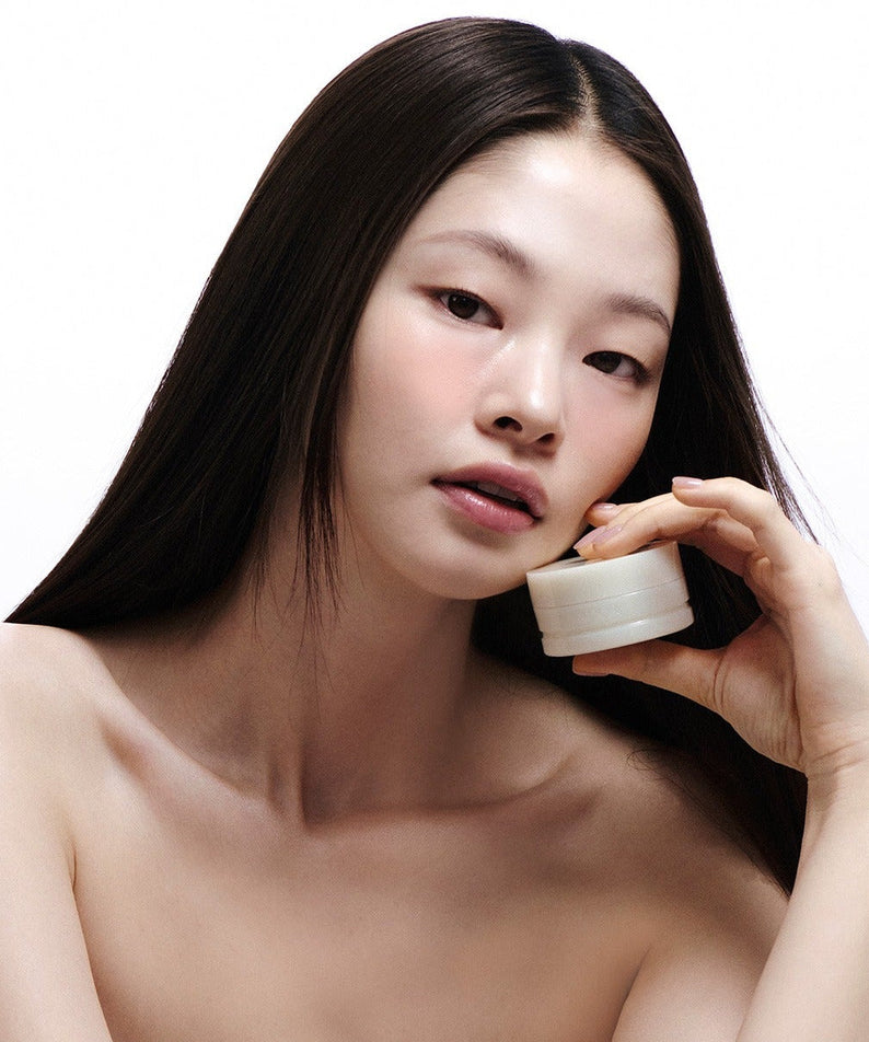 Model showcasing LADOR Body Multi Balm 30g, holding the product with a clean and minimalistic background.