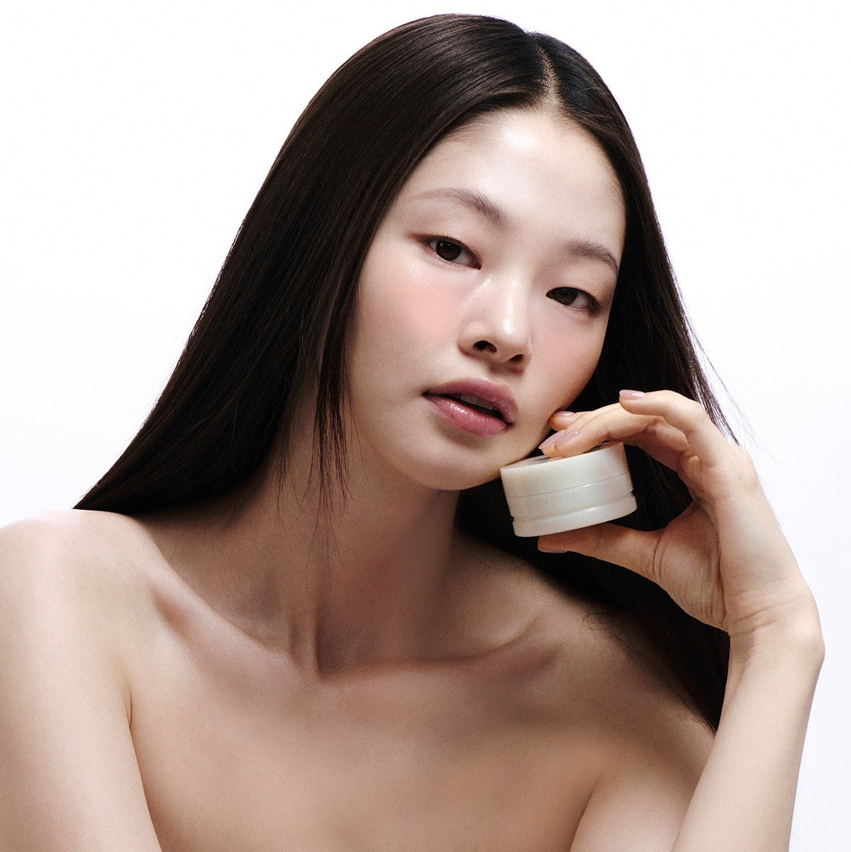 Model showcasing LADOR Body Multi Balm 30g, holding the product with a clean and minimalistic background.