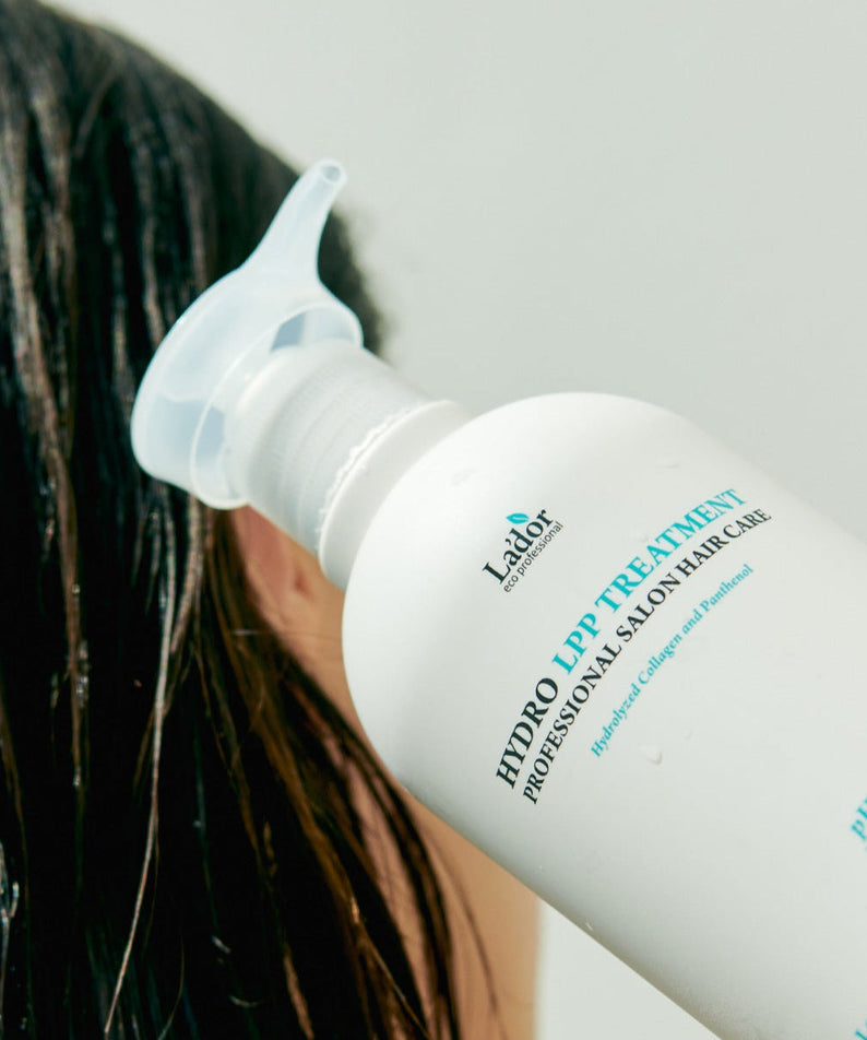 LADOR Hydro LPP Protein Treatment 530ml being applied to wet hair for salon-quality care.