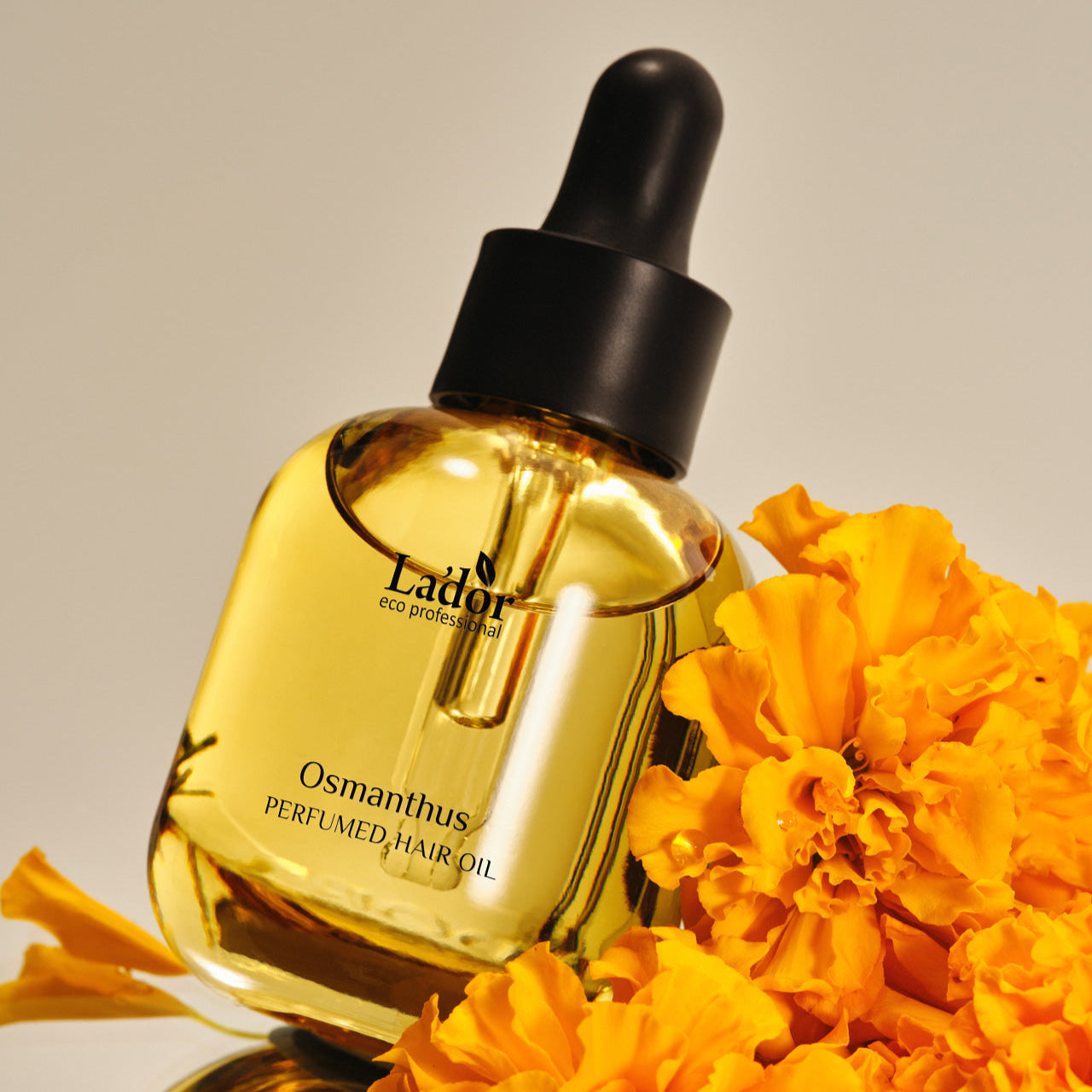 LADOR Perfume Hair Oil 30ml bottle with orange flowers, enhancing hair fragrance and shine, against a neutral background.