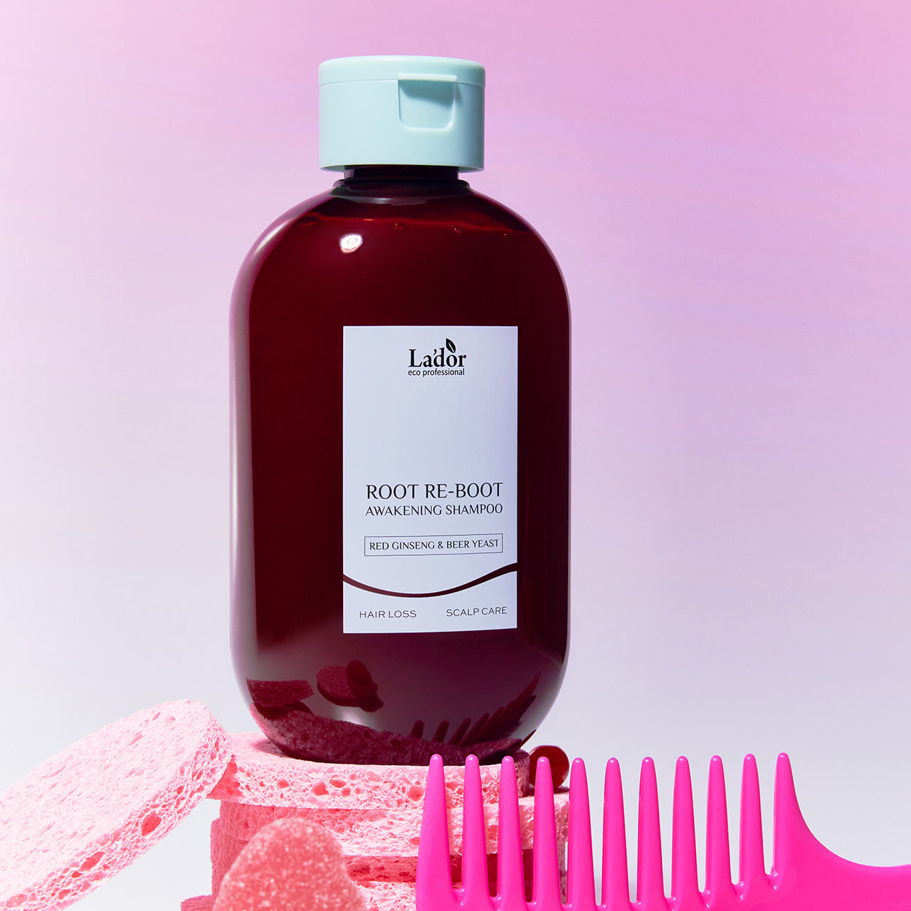 LADOR Root Reboot Custom Hair Loss Shampoo 4 Types bottle with pink comb and sponge background.
