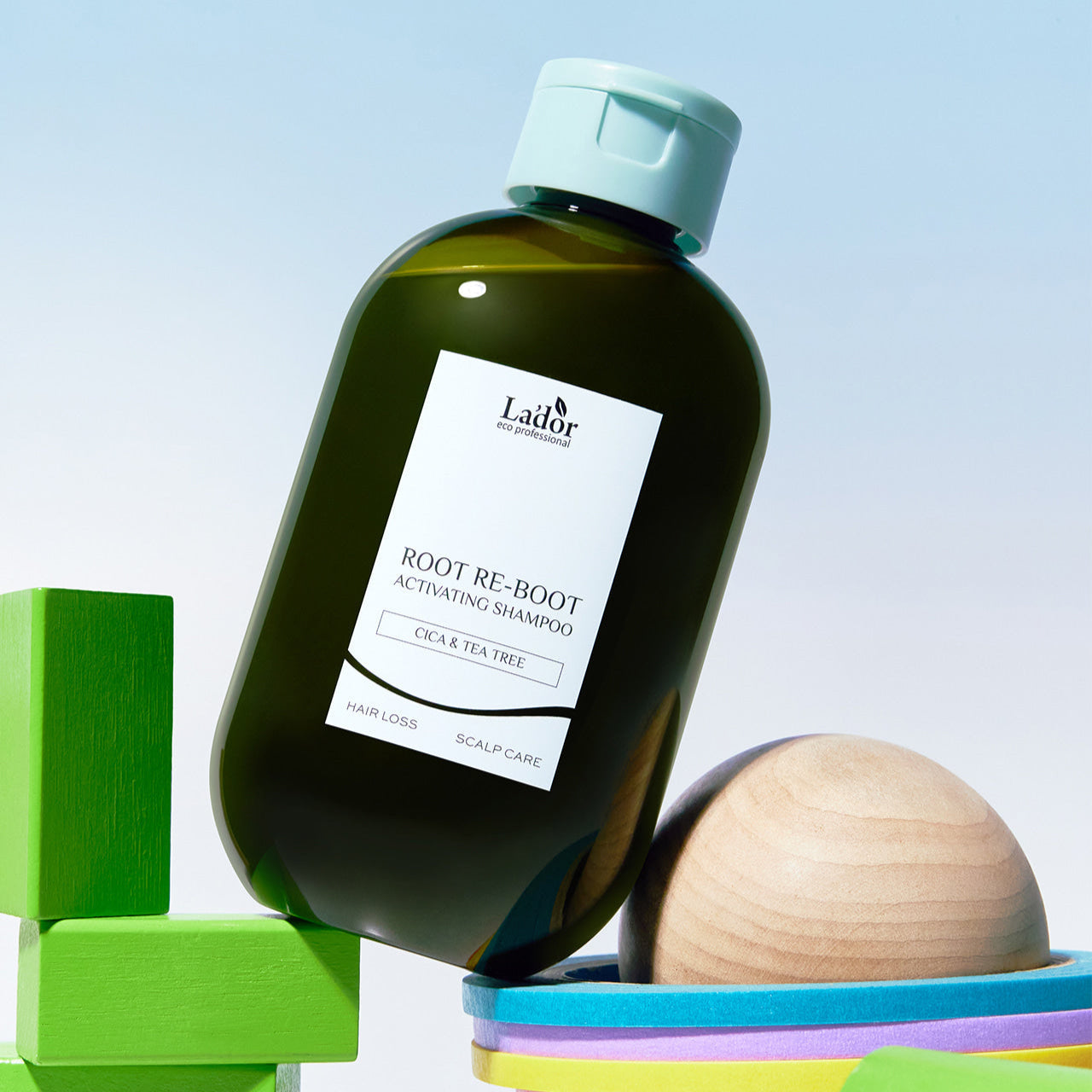 LADOR Root Reboot Custom Hair Loss Shampoo 4 Types bottle displayed with colorful blocks in background.