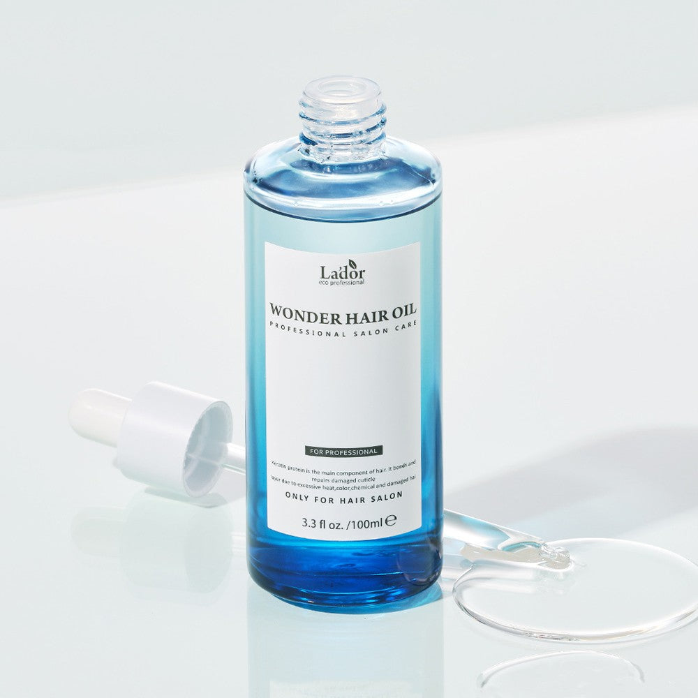 LADOR Wonder Hair Moisture Oil 100ml bottle with dropper, professional salon care for ultimate moisturization.