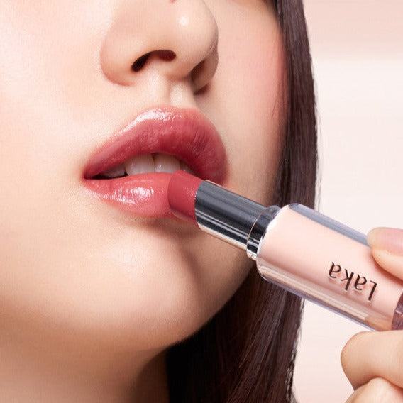 Close-up of woman applying LAKA Bonding On Lips Lipstick for a vibrant look.