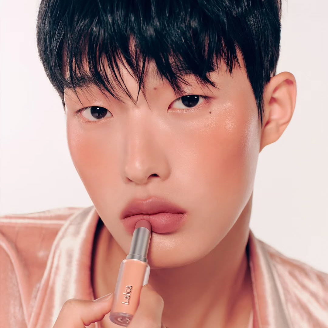 Person applying LAKA Bulky Matte Lipstick to lips, showcasing the product's rich, matte finish.