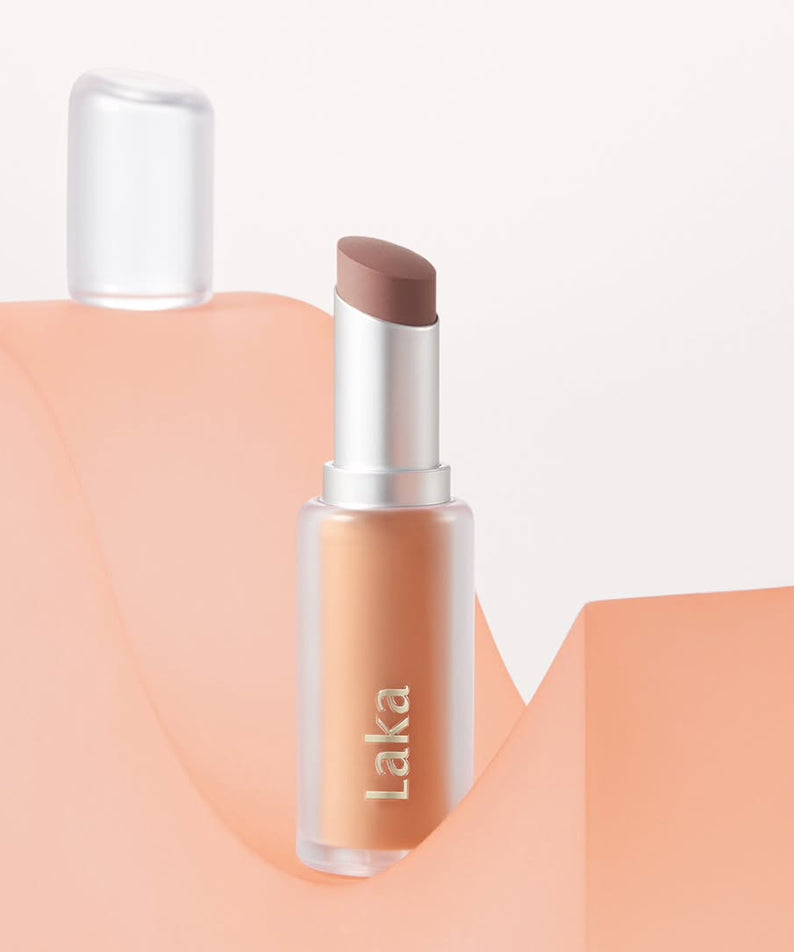 LAKA Bulky Matte Lipstick on peach background, showcasing elegant matte finish and sleek design for beauty enthusiasts.