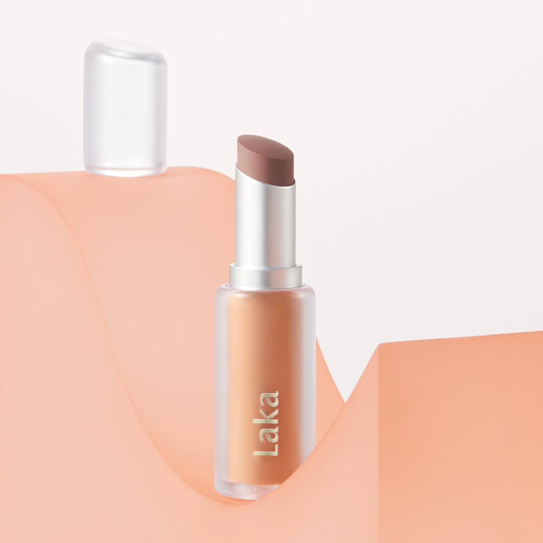 LAKA Bulky Matte Lipstick on peach background, showcasing elegant matte finish and sleek design for beauty enthusiasts.