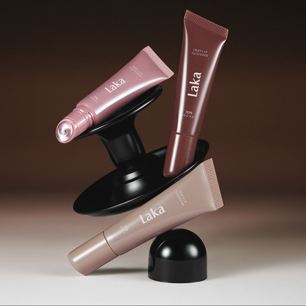 Three tubes of LAKA Fruity Lip Glossionner showcased on a stylish black stand with elegant design and vibrant colors.