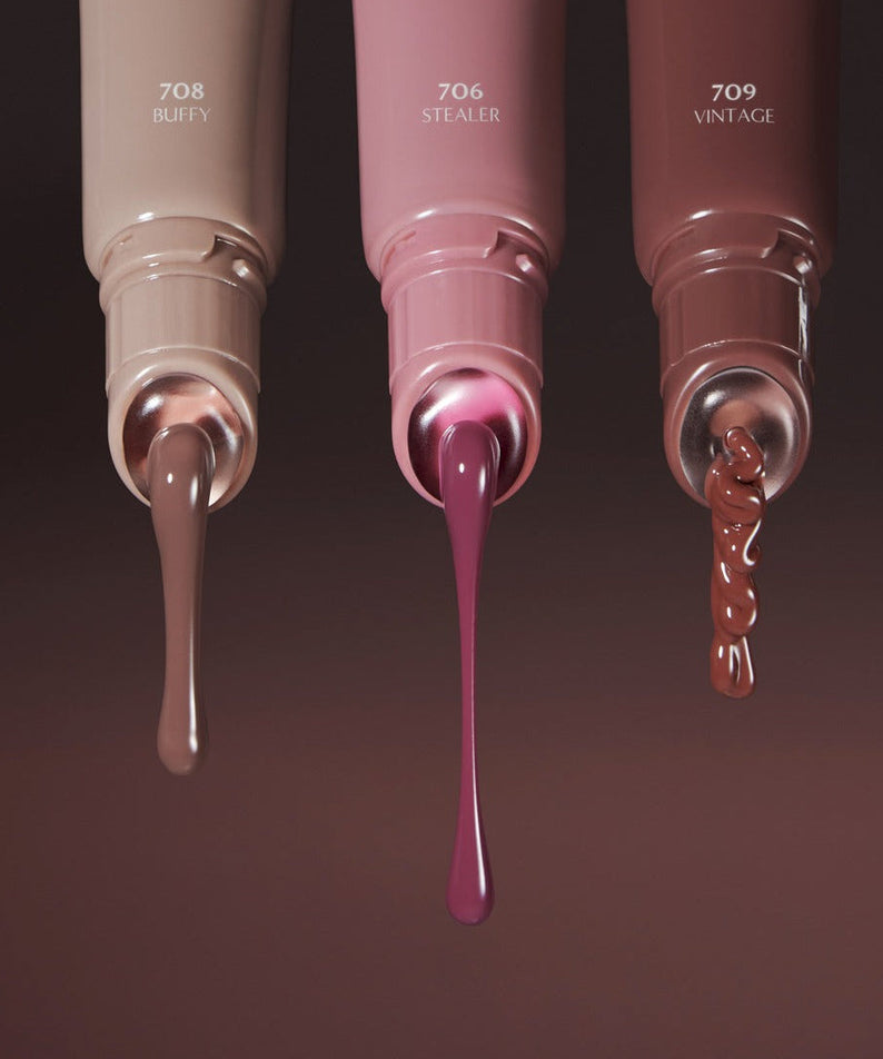 Three tubes of LAKA Fruity Lip Glossionner in shades Buffy 708, Stealer 706, and Vintage 709 with dripping lip gloss.
