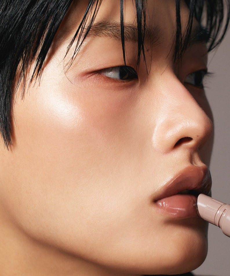Person applying LAKA Fruity Lip Glossionner for a glossy finish on lips.