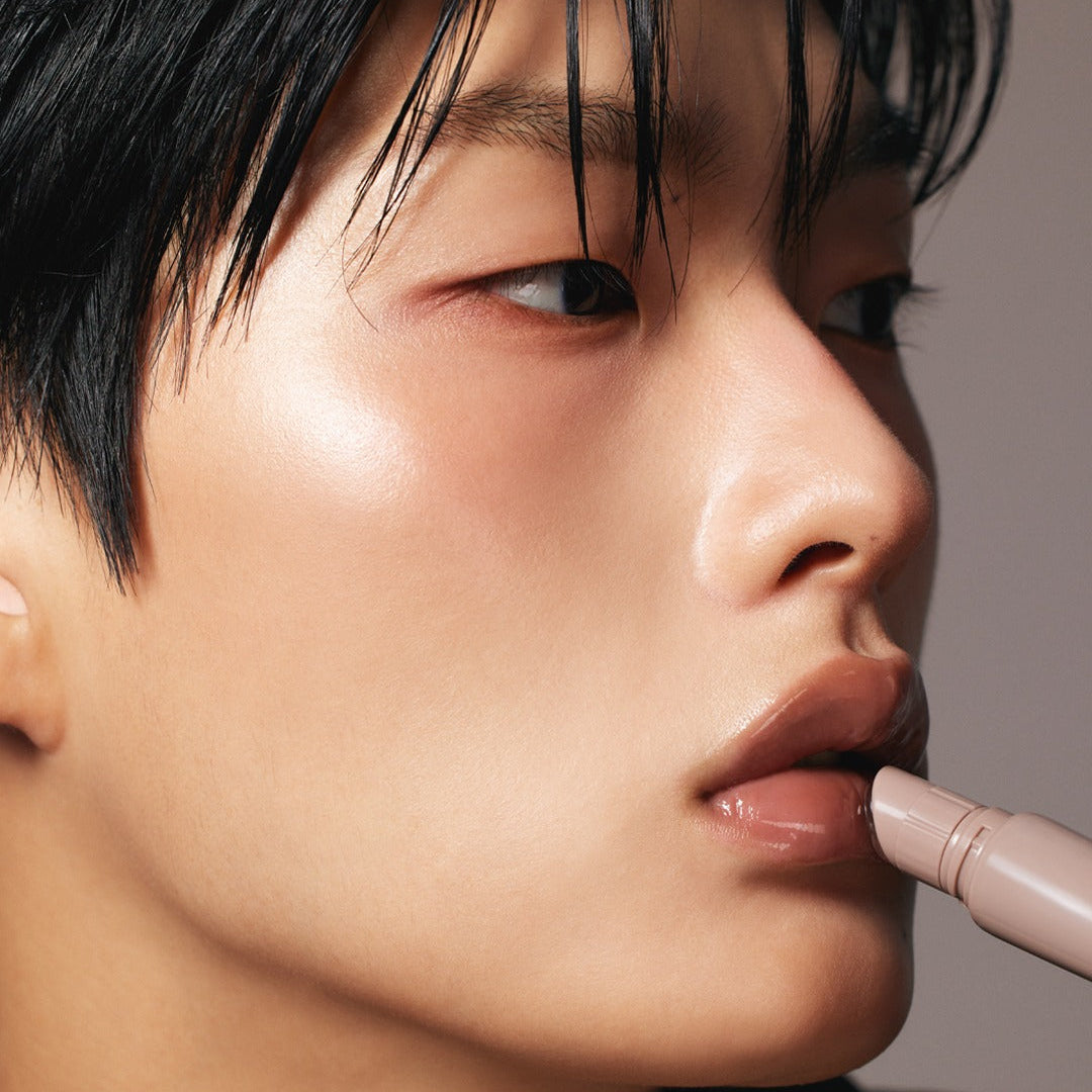 Person applying LAKA Fruity Lip Glossionner for a glossy finish on lips.