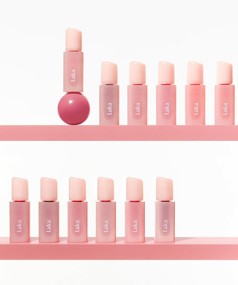 Display of LAKA Popping Ballon Tint makeup bottles on a pink shelf