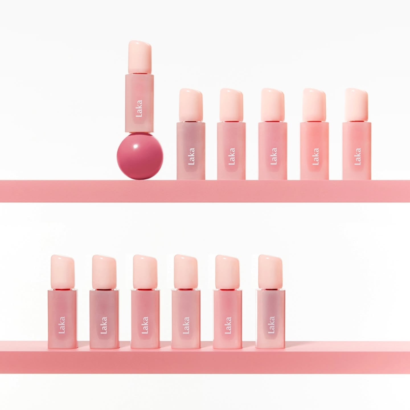 Display of LAKA Popping Ballon Tint makeup bottles on a pink shelf