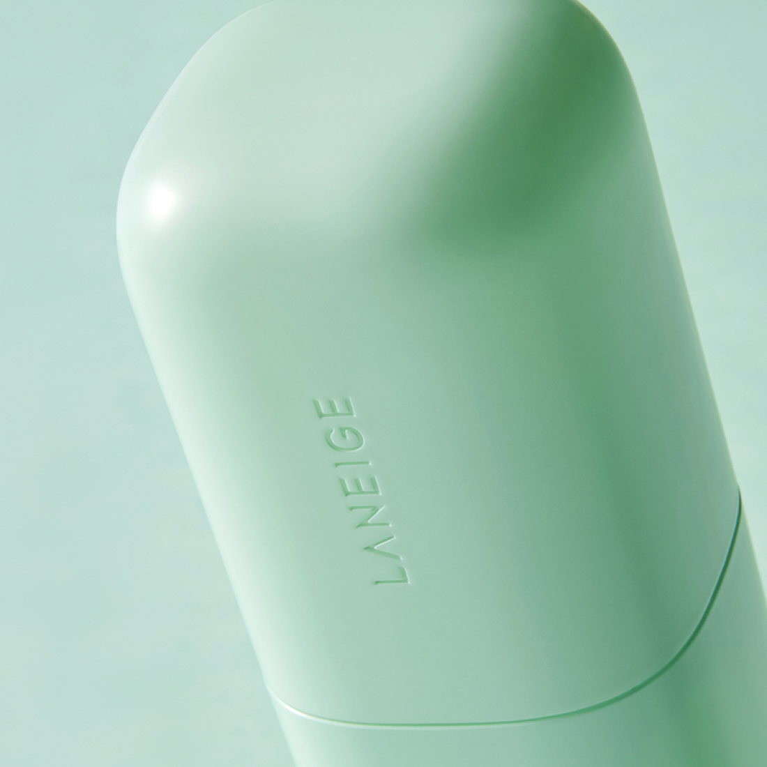 LANEIGE Skin Veil Base SPF28/PA++ 30ml bottle close-up on green background
