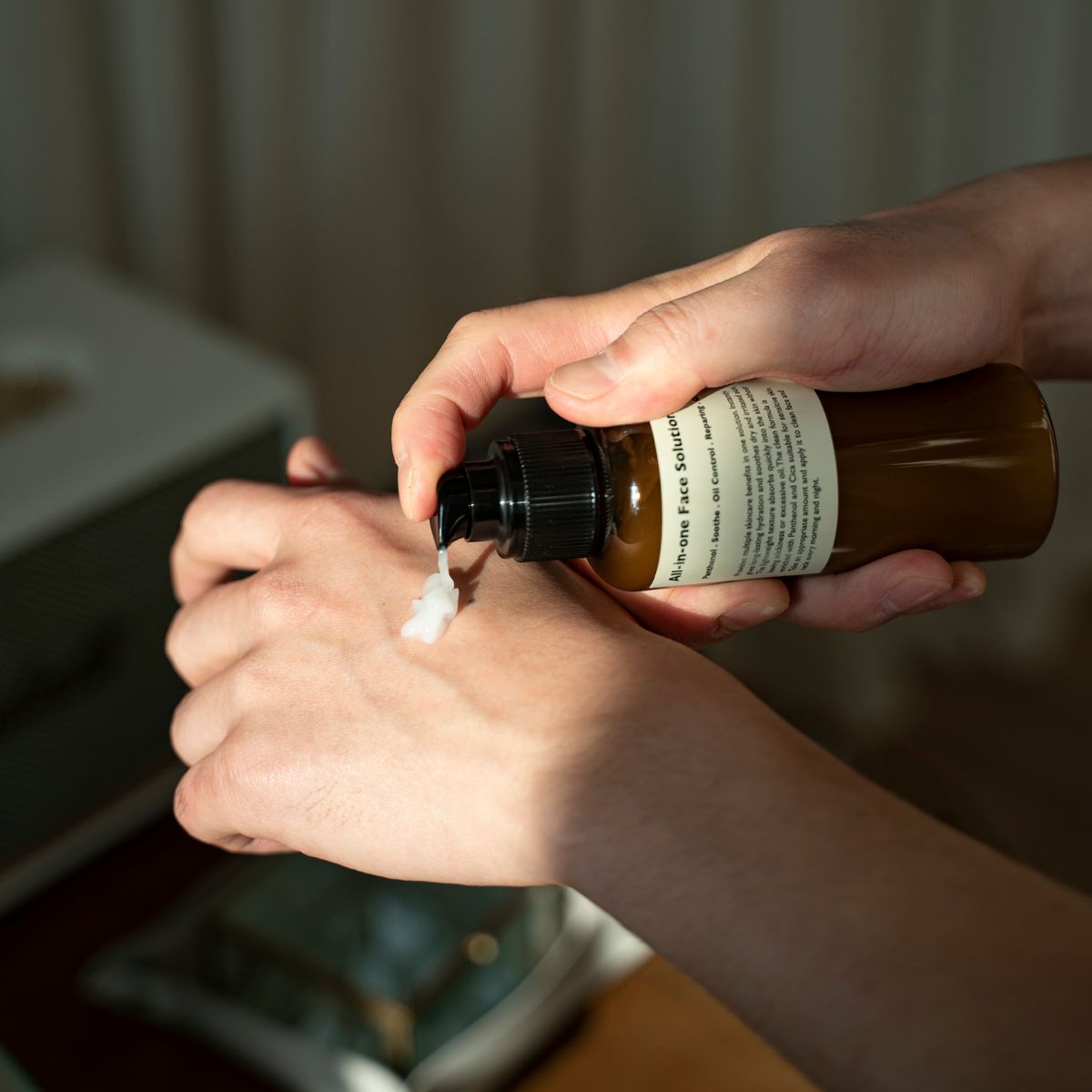 Gentleman Korea applying LAZY SOCIETY All-in-One Face Solution 150g cream on hand, Korean skincare for men