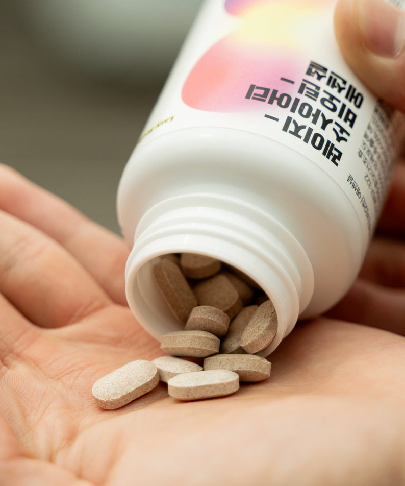 LAZY SOCIETY Biotin Essentail Wholesale - Gentleman Korea product shot of pills poured from bottle into hand, Korean skincare supplement for men