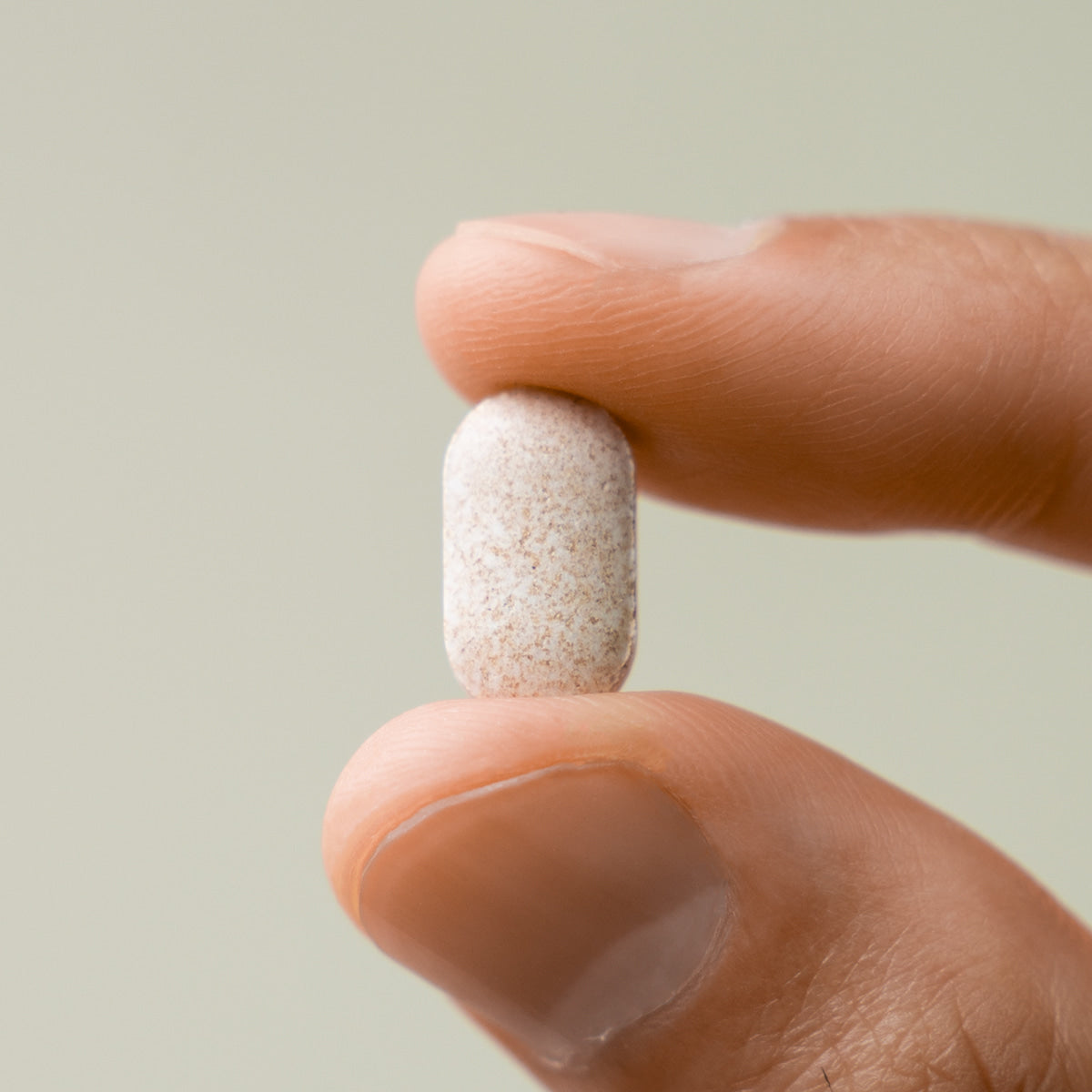 LAZY SOCIETY Biotin Essentail Wholesale - Gentleman Korea men's skincare biotin tablet close-up held between fingers