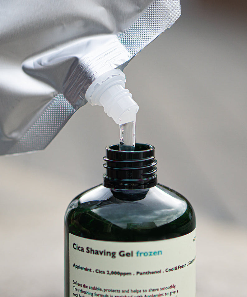 LAZY SOCIETY Frozen Shaving Gel Refill Set - Gentleman Korea refill pouch pouring into dark green shaving gel bottle