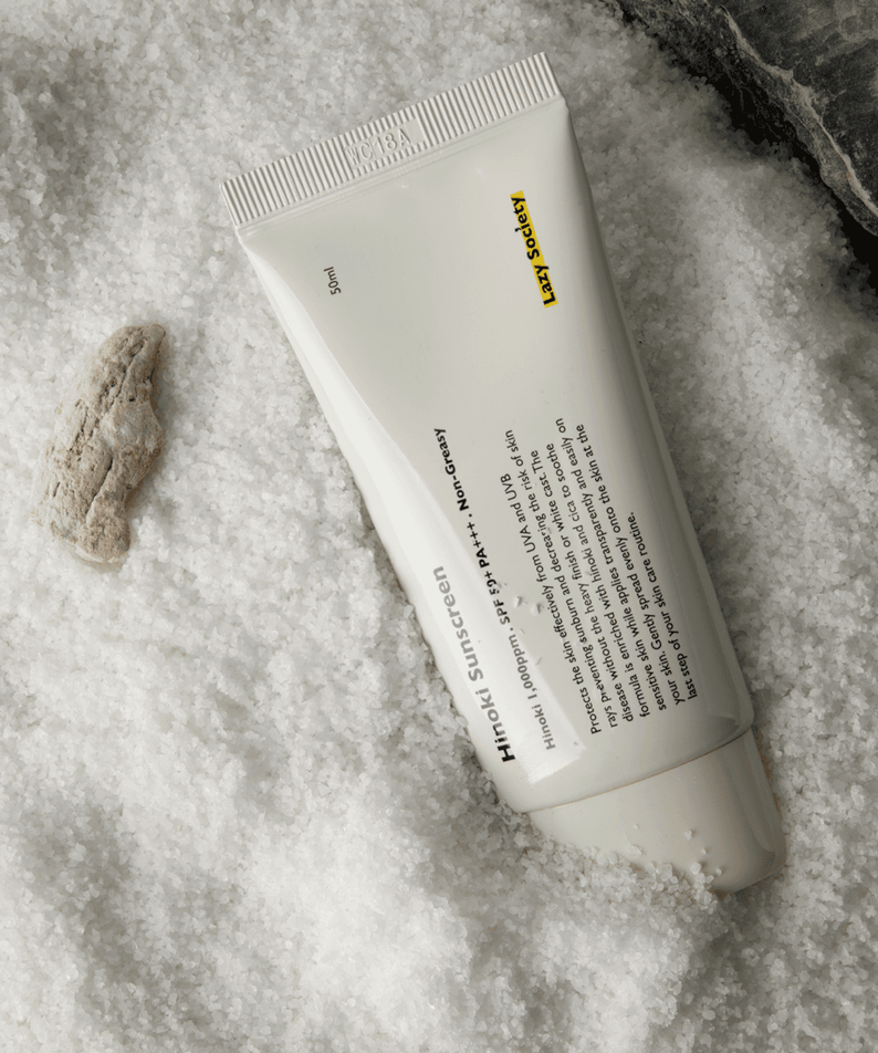 LAZY SOCIETY Hinoki Sunscreen SPPF 50+ PA+++ 50ml tube on textured white background, Korean men’s sunscreen from Gentleman Korea