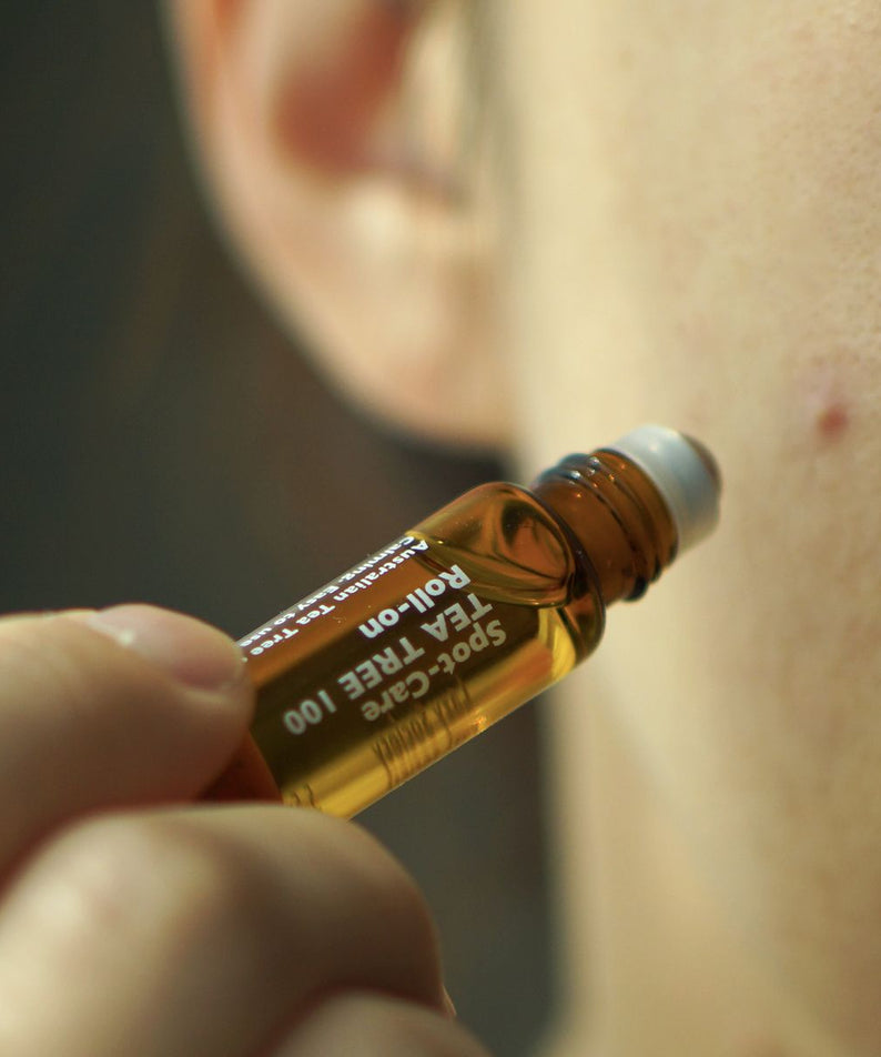 Gentleman Korea applying LAZY SOCIETY Spot Care Tea Tree 100 Roll on 5.5ml to a facial blemish for men’s skincare