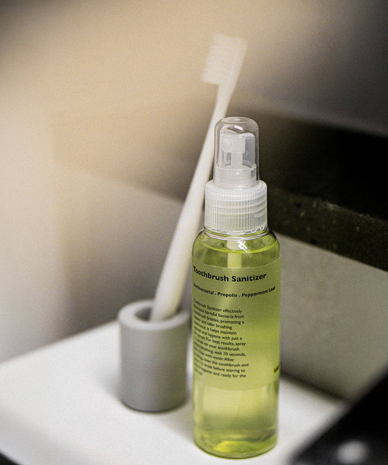 Gentleman Korea product shot of LAZY SOCIETY Toothbrush Sanitizer 100ml bottle next to toothbrush on bathroom counter, Korean skincare for men