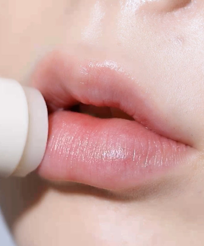 Application of LEMIU Sole Mood Vegan Lip Balm on lips for hydration and vegan beauty.