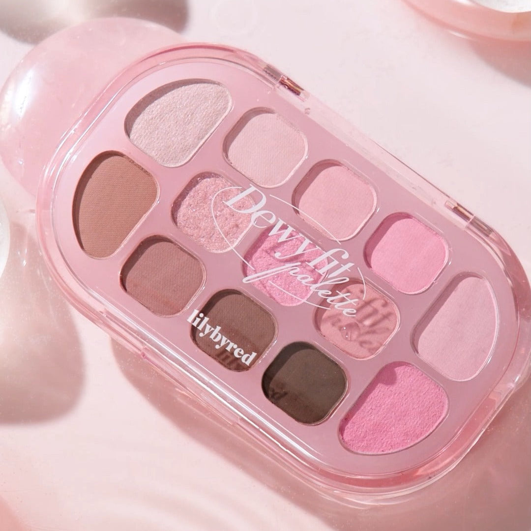 LILYBYRED Dewy Fit Palette showcasing a variety of pink and neutral eyeshadow shades with a glossy finish in a compact case.