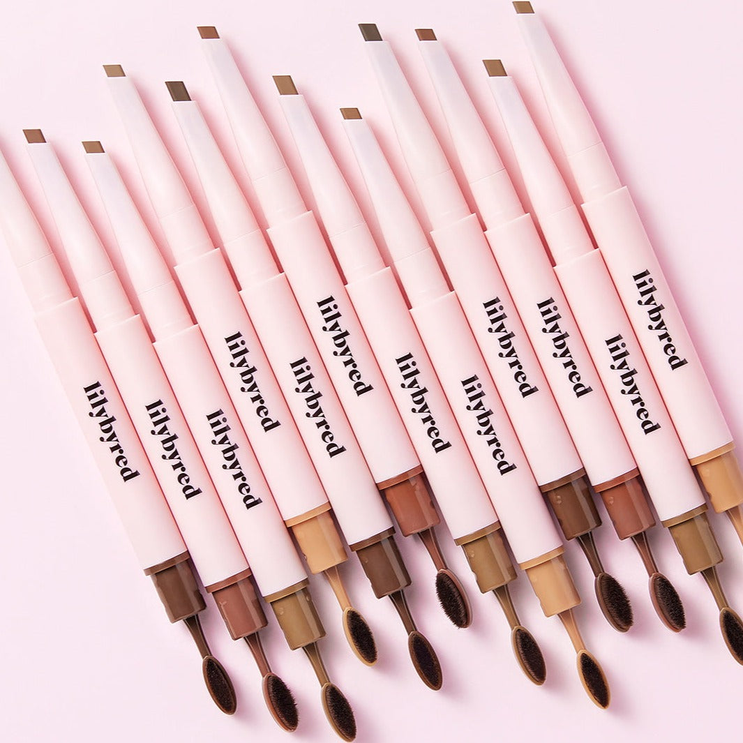 Array of LILYBYRED Hard Flat Brow Pencil in various shades with dual-ended design on a pink background.