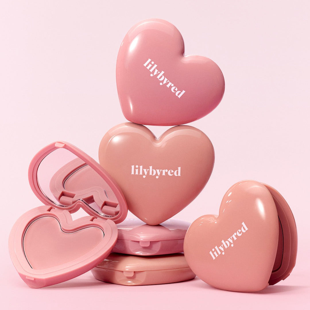 LILYBYRED Love Beam Cheek Balm in heart-shaped compact cases, showcasing the product design and packaging.