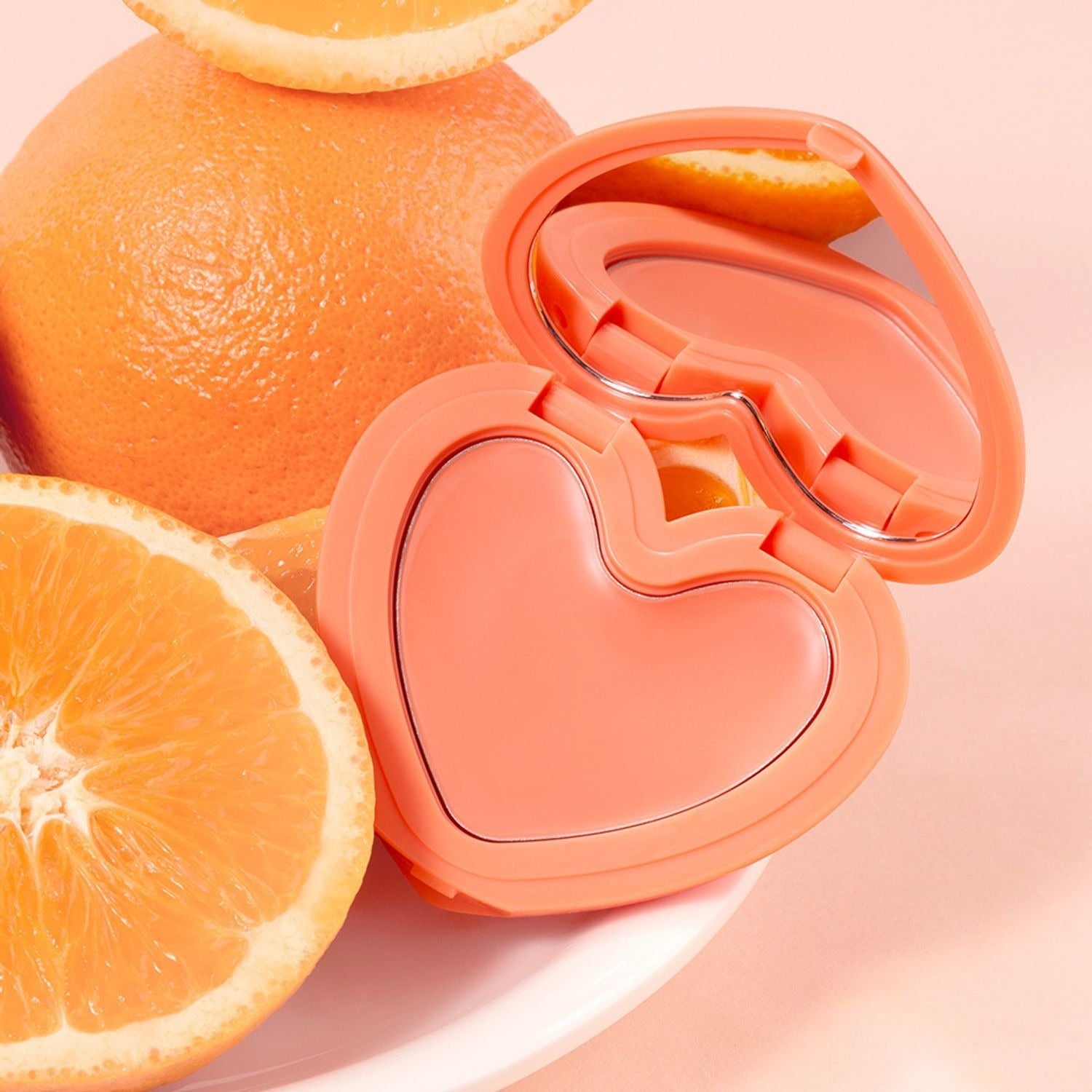 LILYBYRED Love Beam Cheek Balm in heart-shaped compact with oranges