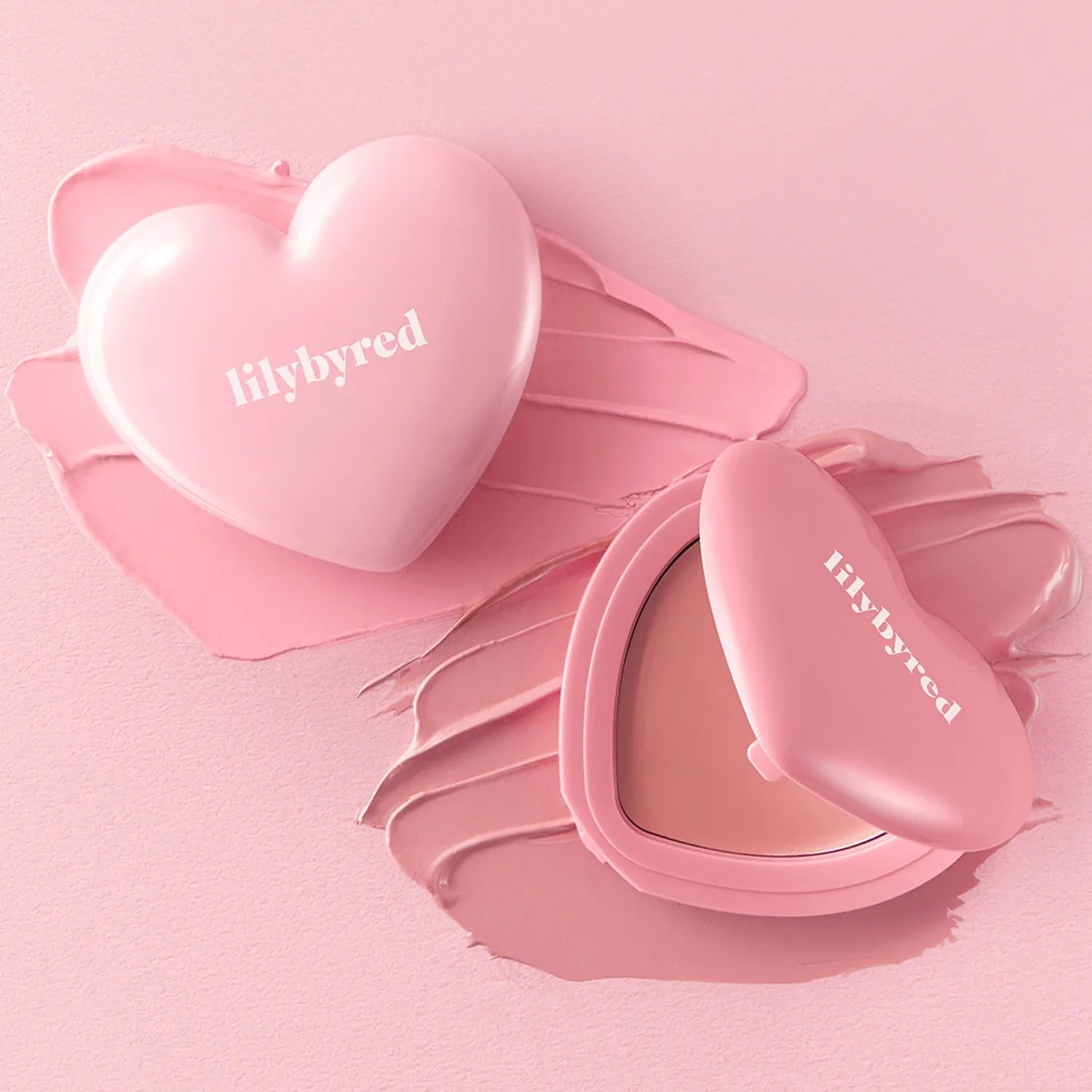 LILYBYRED Love Beam Cheek Balm in heart-shaped blush container on pink background