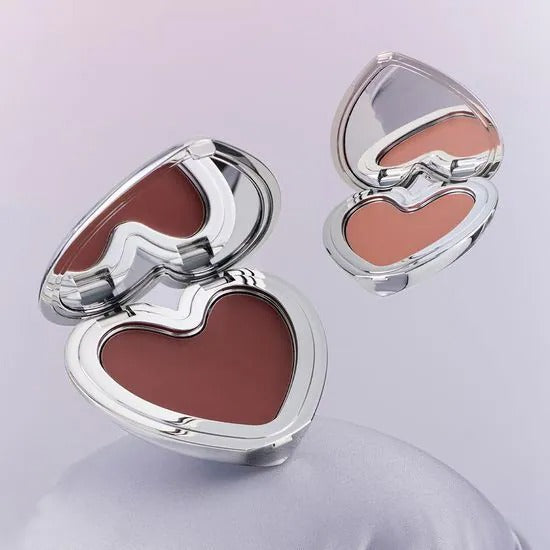 LILYBYRED Love Beam Cheek Mousse in heart-shaped silver compact showcasing vibrant shades.