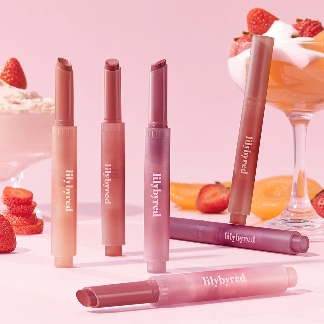 LILYBYRED Milky Blur Fondue Bar makeup collection with lipstick shades set against a strawberry and dessert backdrop.