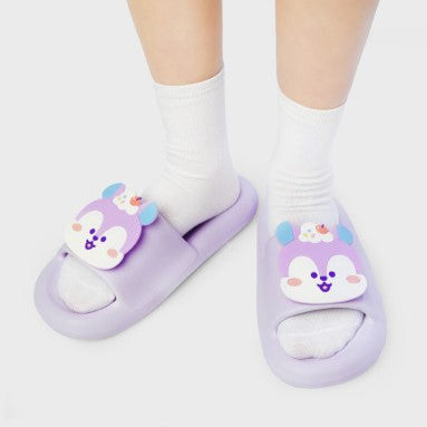 Person wearing LINE FRIENDS BT21 On The Cloud Edition Slippers with purple and white design, featuring adorable character motifs.