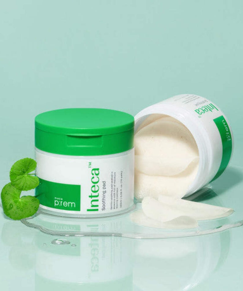 MAKE P:REM Inteca Trouble Soothing Pads 70 sheets in green packaging with open lid, highlighting soothing pads and botanical elements.