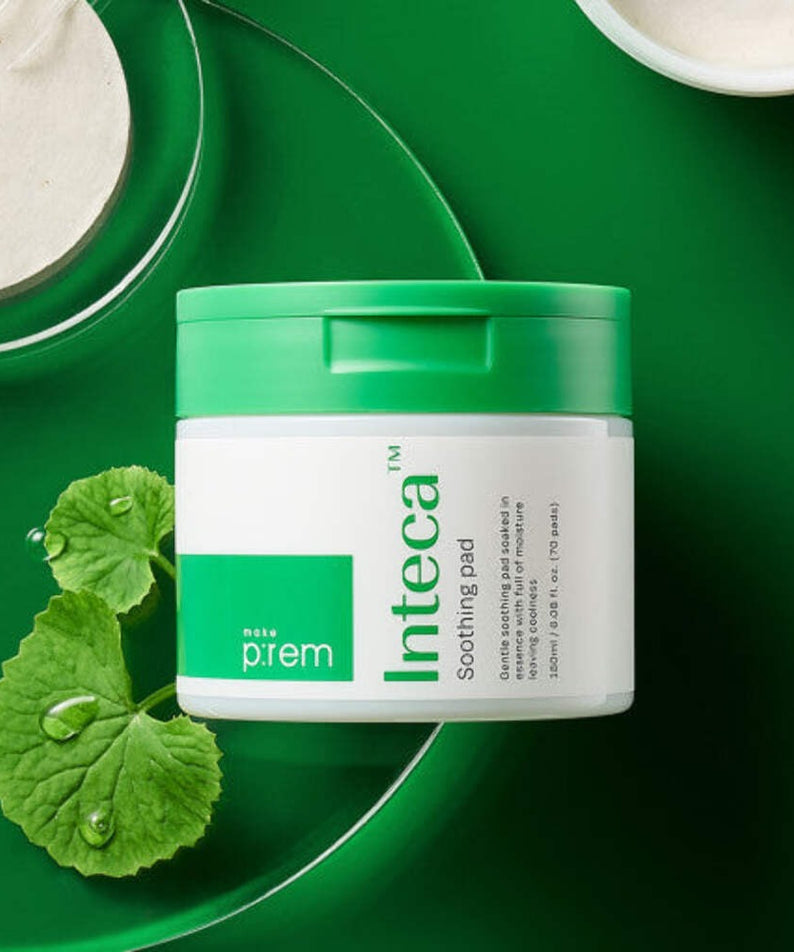 MAKE P:REM Inteca Trouble Soothing Pads 70 sheets container on green background with natural elements