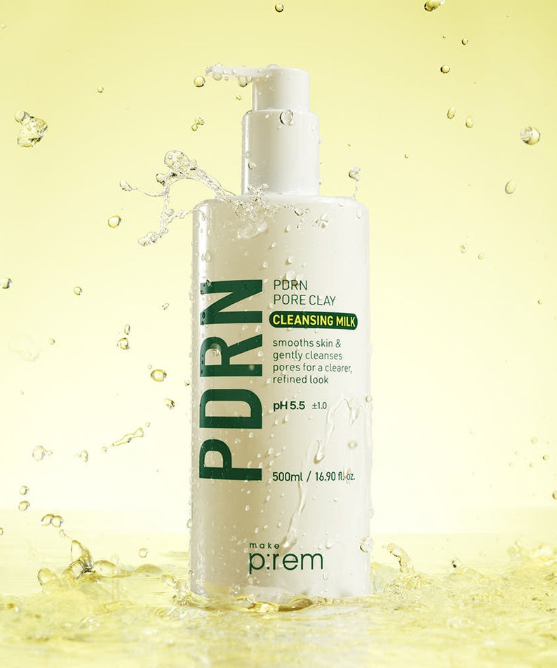 Bottle of MAKE P:REM PDRN Pore Clay Cleansing Milk 500ml with water splashes on yellow background