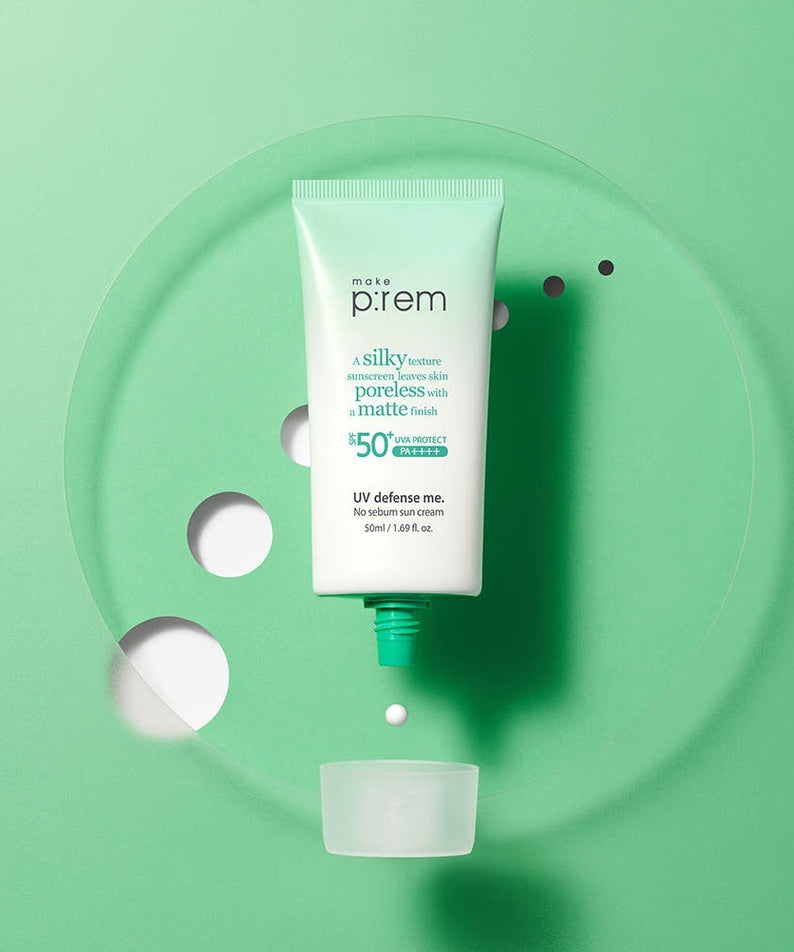 MAKE P:REM UV Defense Me No-Sebum Sunscreen 50ml on a green background with an open cap