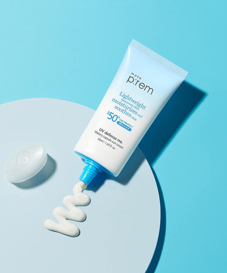 MAKE P:REM UV Defense Me Watery Capsule Sunscreen 50ml SPF50+ PA++++ displayed on blue surface, showcasing lightweight moisturizing formula.