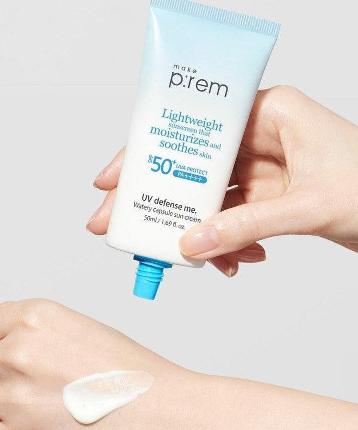 Person holding MAKE P:REM UV Defense Me Watery Capsule Sunscreen 50ml SPF50+ PA++++ next to hand with applied sunscreen.