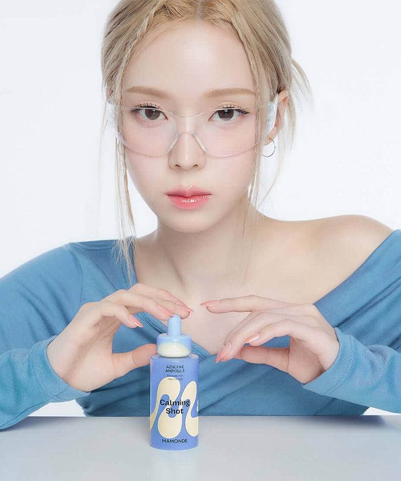 Woman holding MAMONDE Calming Shot Azulene Trace Moisture Ampoule 50ml, highlighting skincare benefits.
