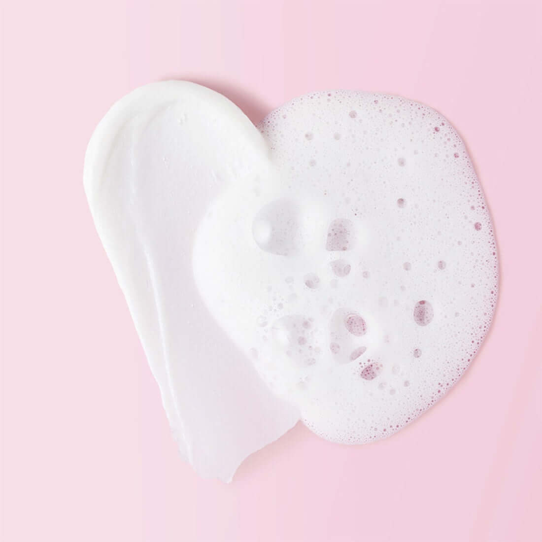 Texture of MAMONDE Ceramide Amino Foam 120g on a pink background, showing smooth lather and creamy foam ideal for gentle cleansing.