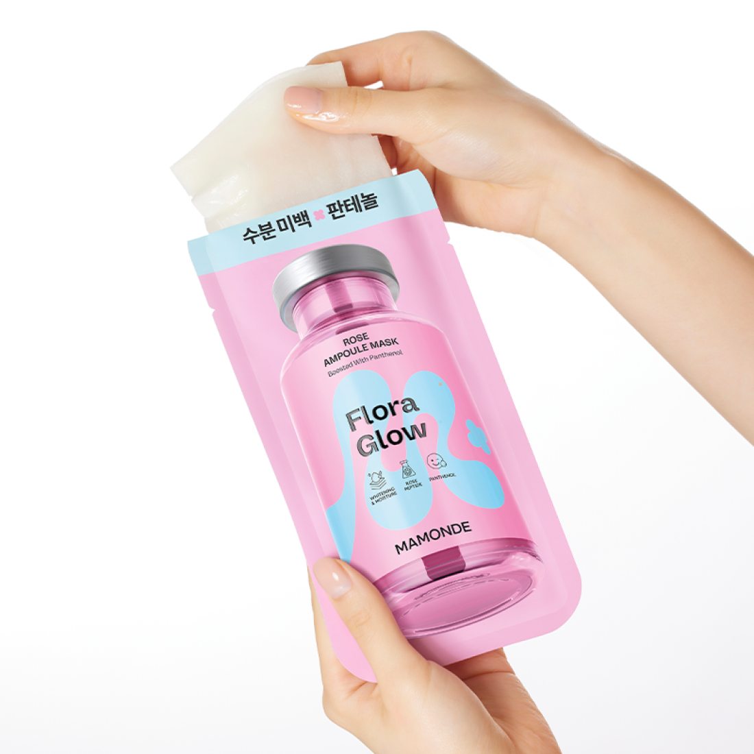 Hands holding MAMONDE Flora Glow Rose Ampoule Mask Pack, featuring a pink bottle design with blue accents.